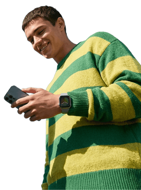 Man smiling while using his phone